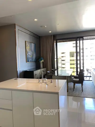 Luxurious open-layout kitchen with modern dining area and city view.