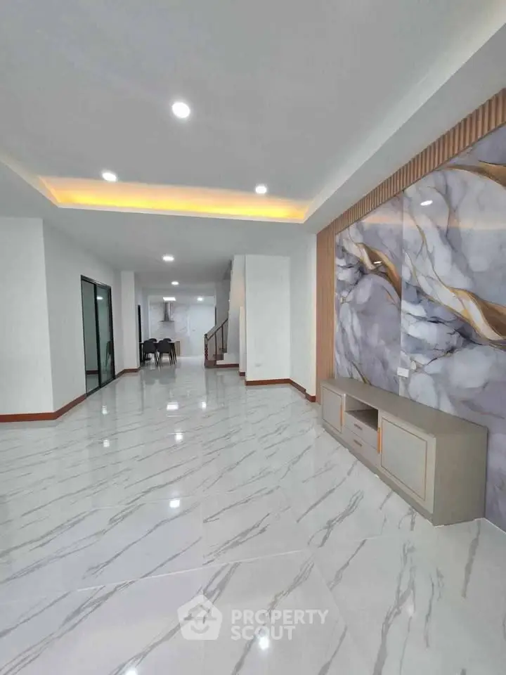 Spacious modern living room with elegant marble flooring and stylish wall design