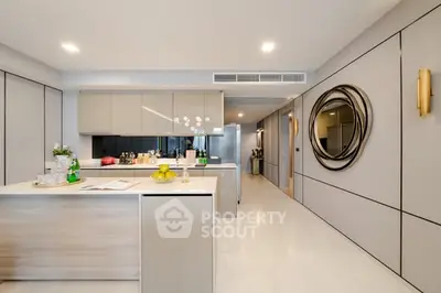 Modern kitchen with sleek cabinetry and island in luxury apartment