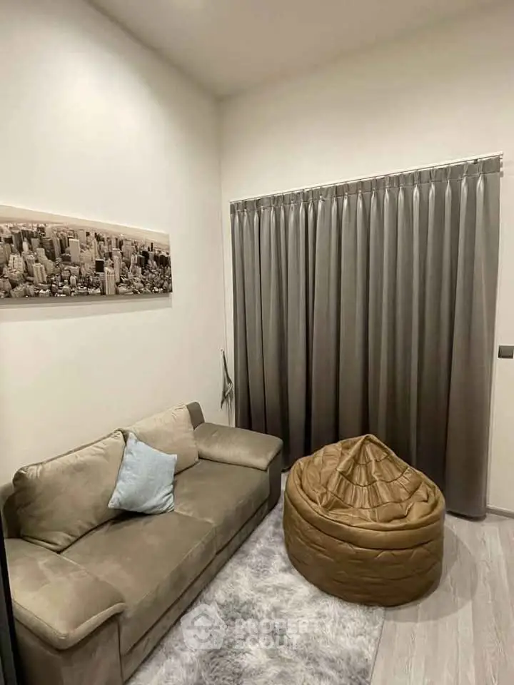 Cozy living room with modern decor, featuring a plush sofa and stylish bean bag chair.