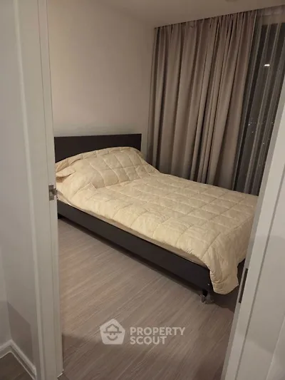 Cozy bedroom with modern decor and elegant curtains, perfect for relaxation and comfort.