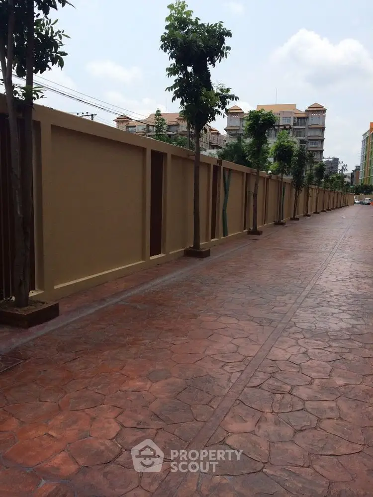Elegant residential pathway with modern architecture and lush greenery