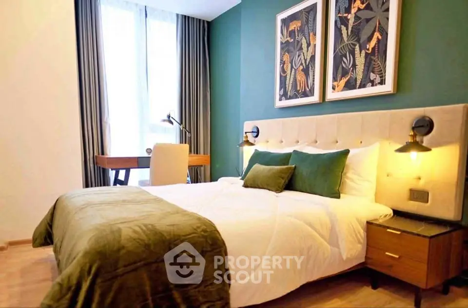 Luxurious bedroom with elegant decor and natural light, featuring a stylish desk and modern artwork.