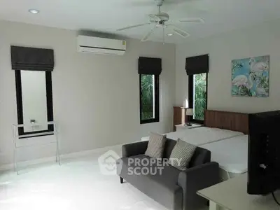 Spacious bedroom with modern decor and natural light