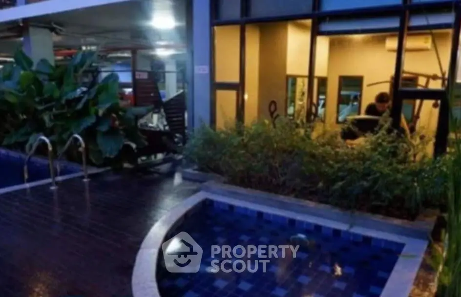 Modern gym with pool view in luxury apartment complex