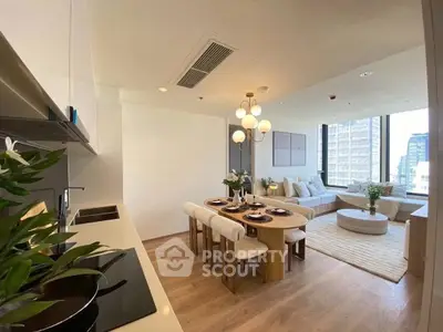 Modern open-plan living room with dining area and city view, featuring elegant decor and natural light.