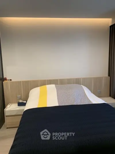 Modern bedroom with stylish bedding and ambient lighting