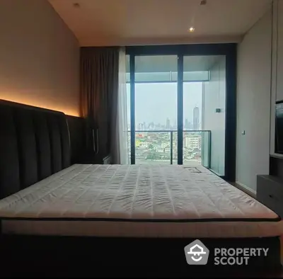 Spacious bedroom with a large bed and floor-to-ceiling windows offering a panoramic city view, modern design, and ample natural light.