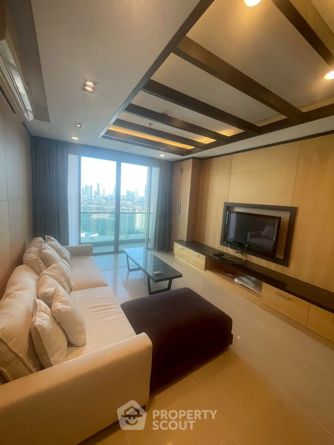 Luxurious living room with city view, modern furniture, and elegant ceiling design.