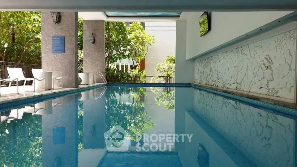 Luxurious indoor pool with elegant design and lush greenery view