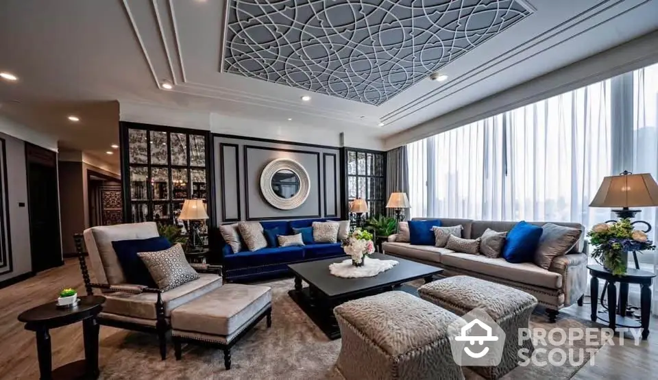 Luxurious living room with elegant decor and large windows offering natural light.