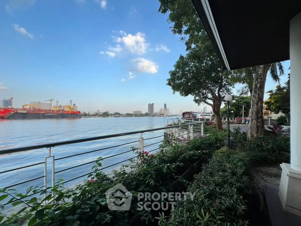 Stunning waterfront view from a lush garden terrace, perfect for serene living.