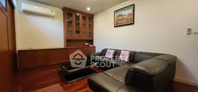 Cozy living room with modern leather sofa and elegant wooden cabinetry