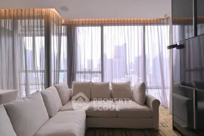 Luxurious living room with panoramic city view and elegant sheer curtains