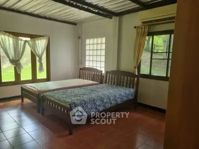 Charming bedroom with twin beds and scenic window view in cozy home