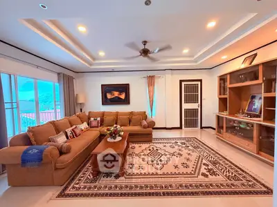 Spacious living room with elegant decor and large windows offering scenic views.