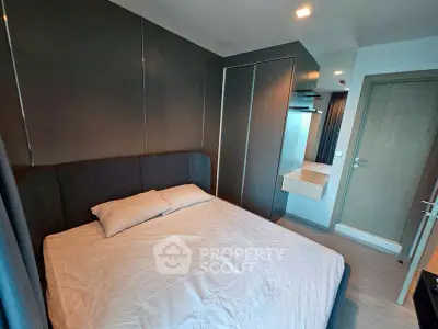 Modern bedroom with sleek design and built-in wardrobe in a stylish apartment.