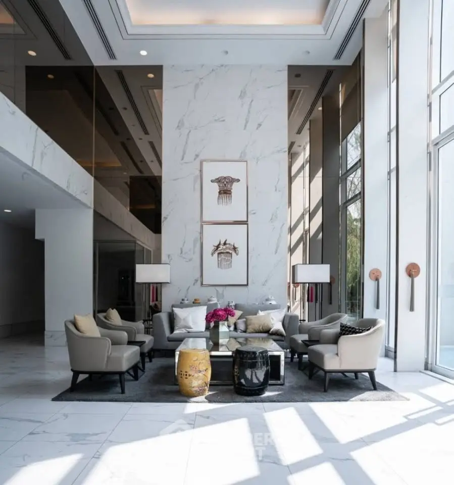 Luxurious modern lobby with elegant seating and high ceilings, perfect for upscale living.