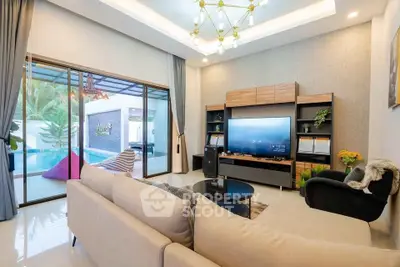 Luxurious living room with pool view, modern decor, and elegant lighting in a stylish home.