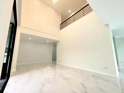 Spacious modern living room with high ceilings and elegant marble flooring