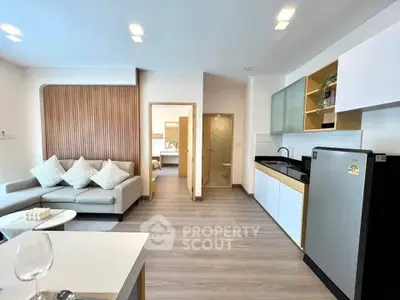 Modern open-plan living room with sleek kitchen and stylish decor