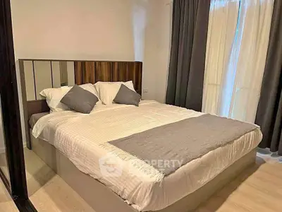 Cozy bedroom with elegant decor and natural light, featuring a comfortable bed and stylish curtains.