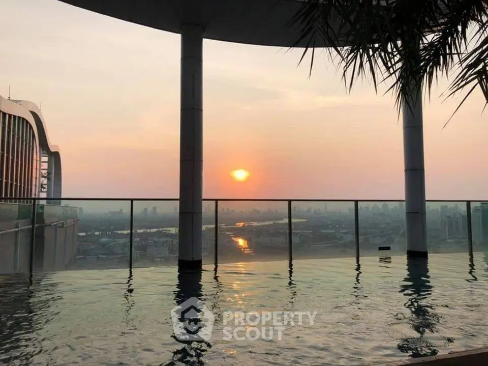 Stunning rooftop pool with panoramic sunset city view, perfect for luxury urban living.
