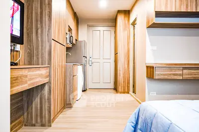 Modern apartment interior with wooden accents and built-in appliances