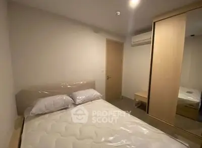 Cozy bedroom with modern furniture and air conditioning in a stylish apartment.