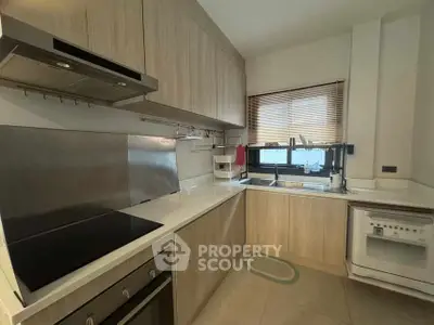Modern kitchen with sleek cabinetry and built-in appliances in a cozy layout.