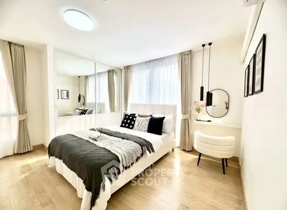 Bright and modern bedroom with stylish decor and large windows in a contemporary apartment.
