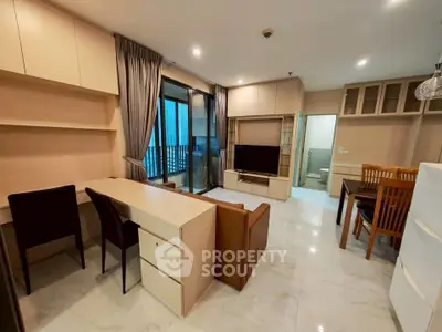 Modern living room with open layout, stylish furniture, and balcony access in a contemporary apartment.