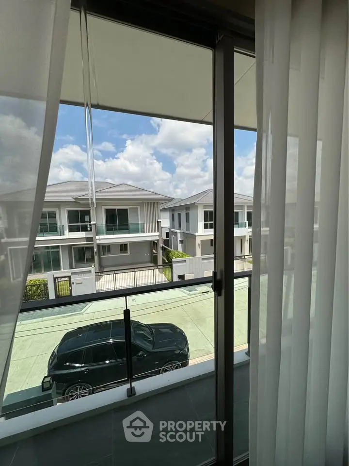 Stunning view from a modern balcony overlooking a serene residential neighborhood.