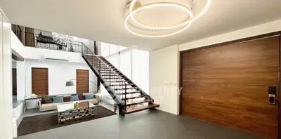 Luxurious modern living room with elegant staircase and stylish lighting