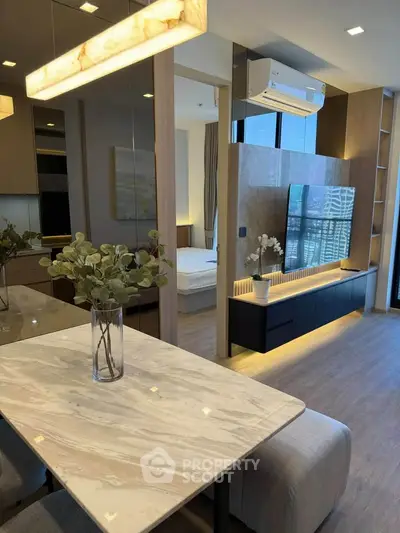 Modern open-plan living room with stylish decor and large TV unit