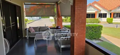 Charming outdoor patio with cozy seating in a suburban home, perfect for relaxation and entertaining.