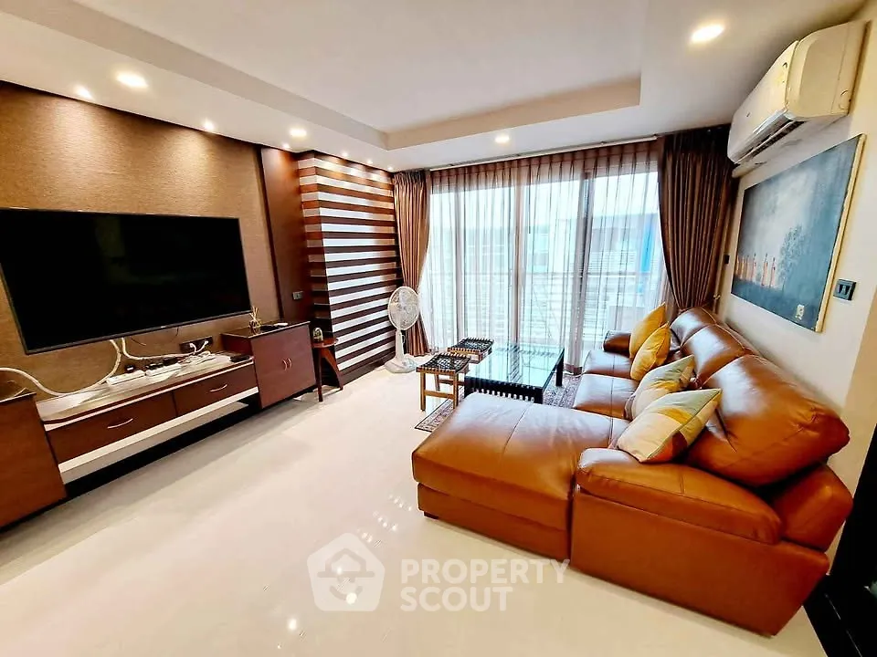 Spacious living room with modern decor and large windows in a luxury apartment.