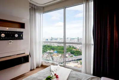 Stunning bedroom with panoramic city view from large window, modern interior design.
