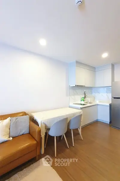 Modern open-layout kitchen with cozy dining area and stylish living room.