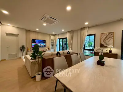 Spacious modern living room with elegant decor and large windows offering natural light.