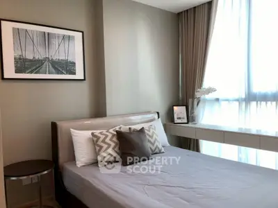 Modern bedroom with stylish decor and large window for natural light