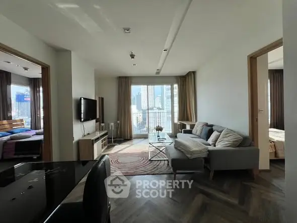 Modern living room with city view, stylish furniture, and natural light