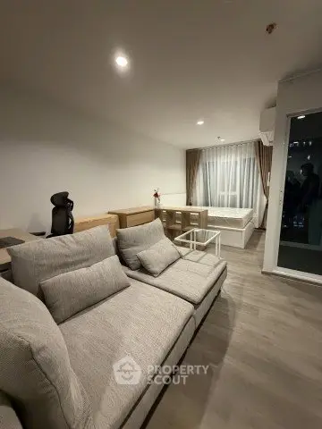 Modern living room with cozy sofa and elegant decor in a stylish apartment.