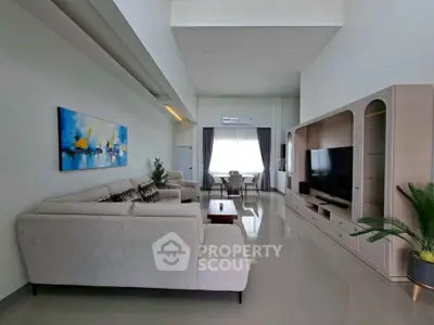 Spacious modern living room with elegant decor and large windows