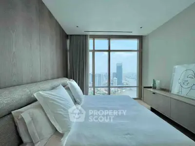Luxurious bedroom with stunning city view from large window, modern decor and elegant furnishings.