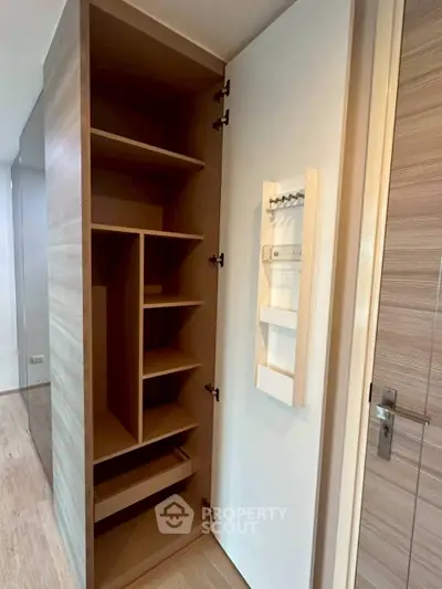 Modern storage closet with wooden shelves and sleek design