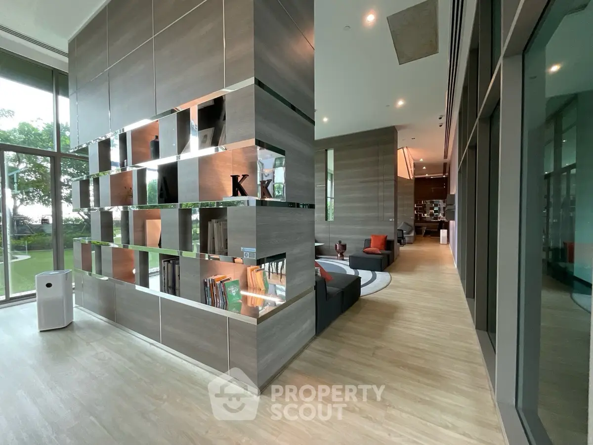 Modern living room with stylish decor and large windows offering garden views