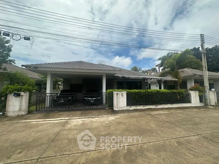 Charming suburban house with spacious driveway and lush greenery.