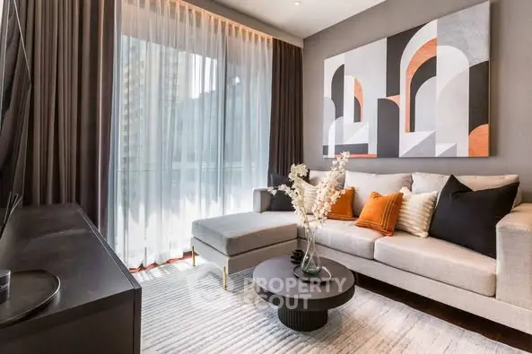Stylish modern living room with elegant decor and large window view.