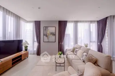 Luxurious modern living room with panoramic city views and elegant decor.